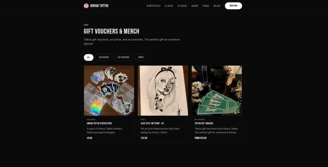 The Amour Tattoo online shop showing gift vouchers and prints for sale alongside the studio's tattoo services