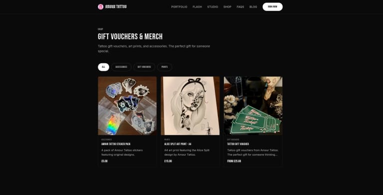 The Amour Tattoo online shop showing gift vouchers and prints for sale alongside the studio's tattoo services